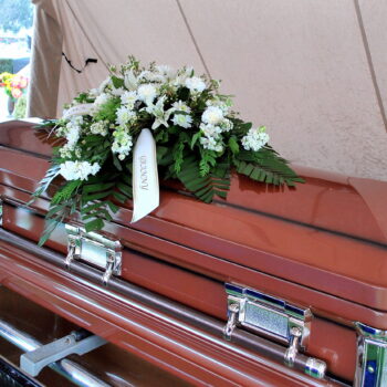 Casket at a funeral service outdoors.